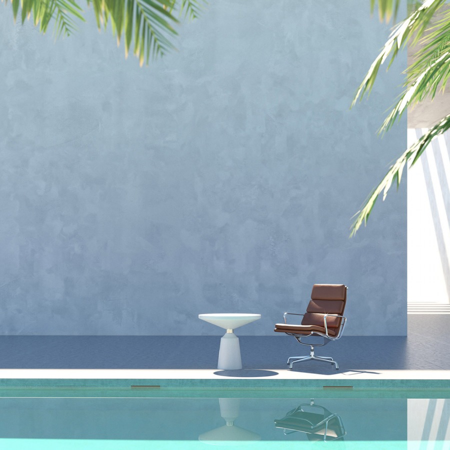 a leather chair and a white table near the pool