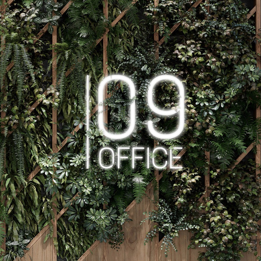 green wall with a neon logo